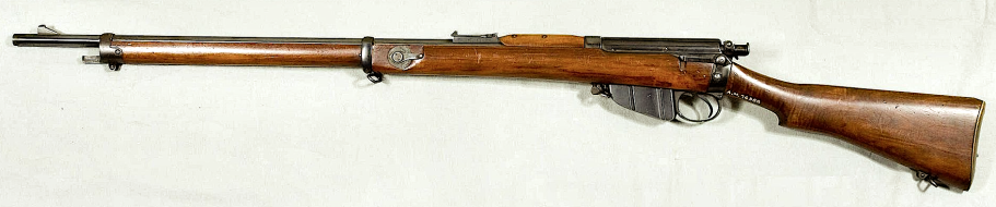 A wooden bolt-action rifle with a long barrel and metal mechanisms. Metford Rifle