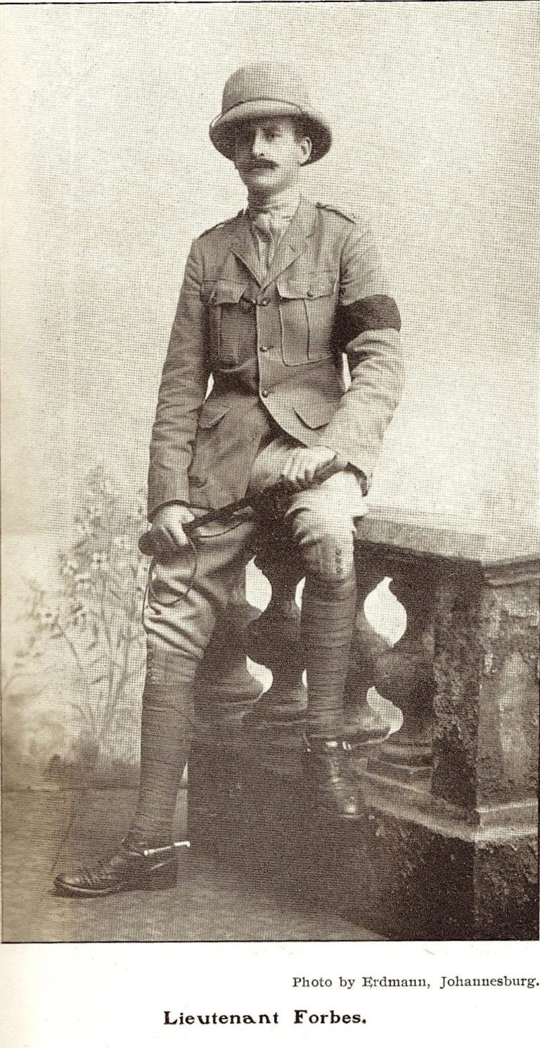 A man in a pith helmet and military uniform stands by a stone railing.