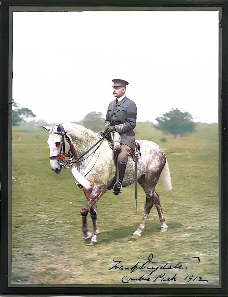 A man in uniform riding a white horse through a grassy landscape.