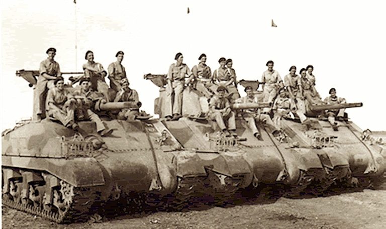 Historical photograph of soldiers posing on top of tanks.