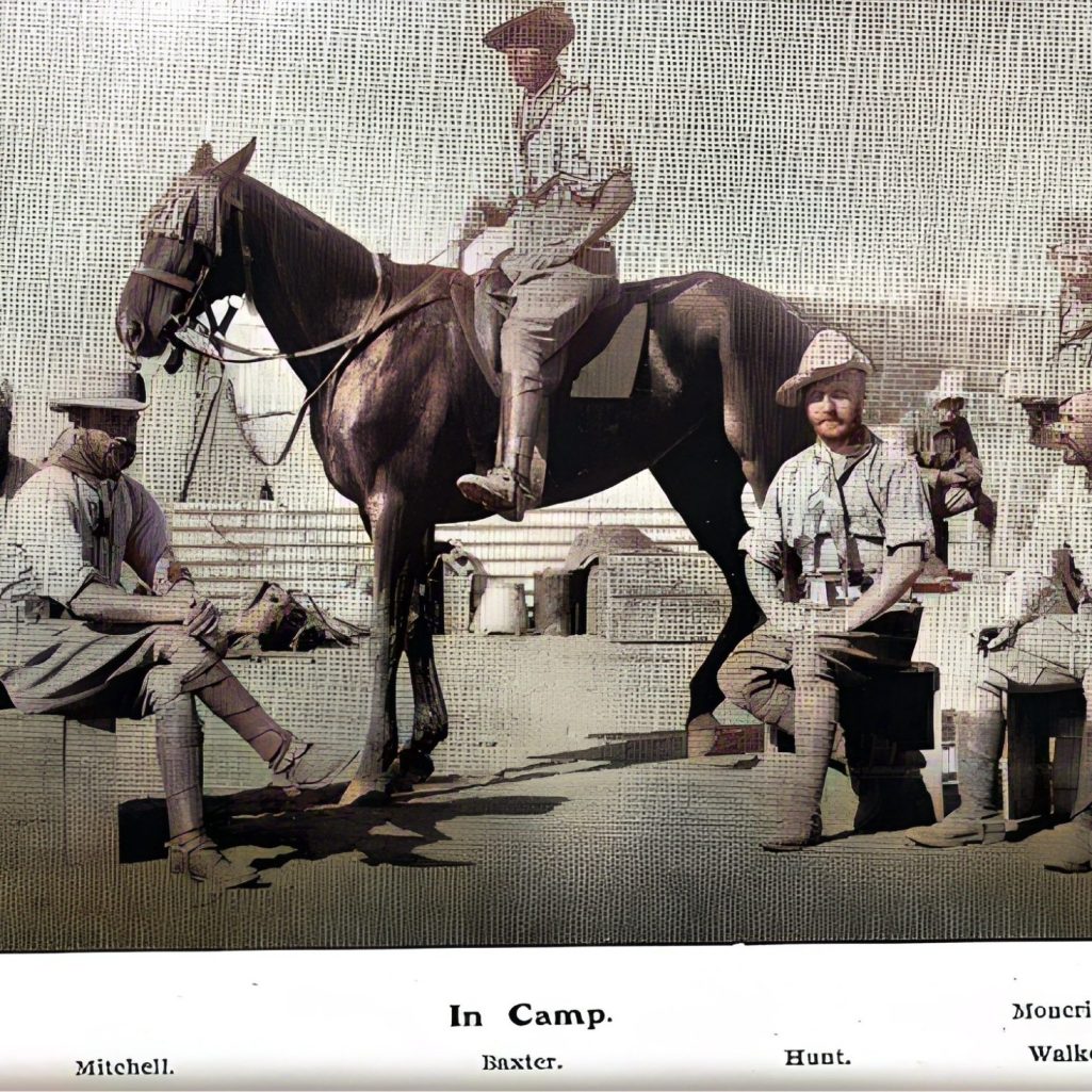 Five men in camp, one on horseback, others seated, wearing military attire.